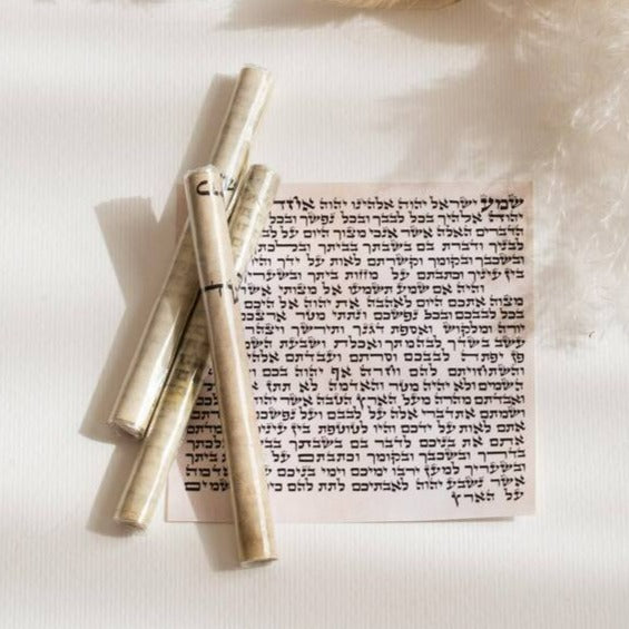 suri-judaica-mezuzah-scrolls-on-klaf-flat-display.jpg